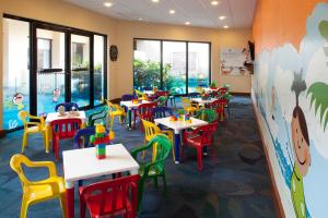 a classroom with tables and chairs in a school cafeteria at Emporio Cancun - Buy All Inclusive Option in Cancún