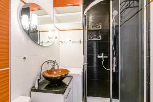 a bathroom with a sink and a shower at Labo Apartment Karmelicka in Warsaw