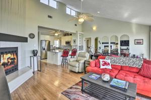 a living room with a red couch and a fireplace at Sunny Home with Decks and Views, Steps to Beach! in Flagler Beach