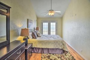 a bedroom with a bed and a ceiling fan at Sunny Florida Home with Decks and View, Steps to Beach in Flagler Beach +25 photos