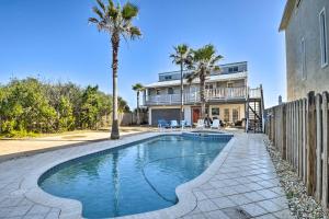 a swimming pool in front of a house with palm trees at Sunny Home with Decks and Views, Steps to Beach! in Flagler Beach