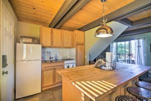 La cuisine est équipée d'un réfrigérateur blanc et de placards en bois. dans l'établissement Cozy Big Bear Cabin with Deck, Grill and Mtn View, à Big Bear City 19 autres photos