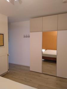 a bedroom with a bed and a sliding glass door at Residentie Romanza in Middelkerke