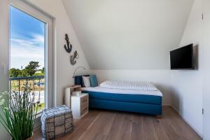 TV a/nebo společenská místnost v ubytování NordseeResort Büsum Ferienhaus 1 Beach House