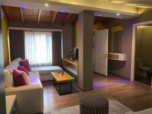 a living room with a couch and a table at Guest House People in Korçë