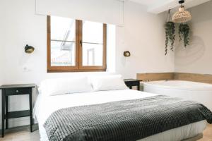 a bedroom with a bed and a bath tub at Jardines Villaverde in Villaverde de Pontones +95 photos