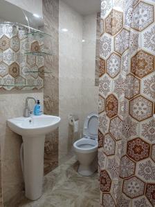 a bathroom with a sink and a toilet at Julia's Place - Apartment, Garden & BBQ in Vagharshapat