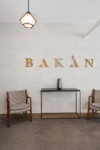 a table and two chairs and a sign on a wall at Bakan- Quartier des Congres, Convention District in Montreal