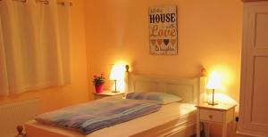 a bedroom with a bed and two lamps on two tables at Connemara Haven Bed and Breakfast in Oughterard