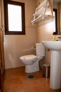 a bathroom with a toilet and a sink at La Casita de Atajate in Atajate