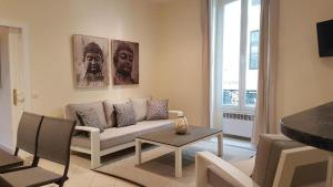 a living room with a couch and a table at Aston - Appartement Centre Ville Massena in Nice