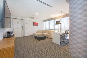 a large living room with a couch and a desk at Presidente InterContinental Guadalajara by IHG in Guadalajara +76 photos