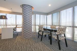 a room with a table and chairs and a column at Presidente InterContinental Guadalajara by IHG in Guadalajara