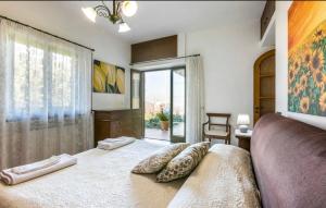 a bedroom with a bed with two pillows on it at Villa Due Golfi in Colli di Fontanelle
