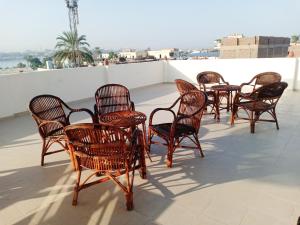 a group of chairs sitting on a roof at The Magic of Luxor private studio apartment on the rooftop in Luxor