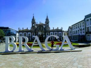 a large metal sign in front of a building at LUCINDA`S HOUSE in Braga