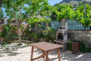a picnic table and an outdoor oven in a yard at Alojamiento Rural El Respiro "Brisa" in Benaocaz