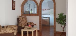 a living room with a couch and a table with a candle at Alojamiento Rural El Respiro "Brisa" in Benaocaz