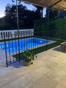 a fence around a pool with a plant next to it at Les Villas du Parc in Antibes