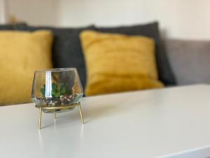 a small glass bowl with a plant in it on a table at Recently Furnished Stylish 3 Bed House by Town and Beach in Blythe