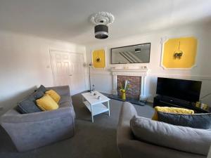 a living room with two couches and a tv at Recently Furnished Stylish 3 Bed House by Town and Beach in Blythe