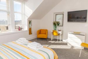 a bedroom with a bed and a desk and a tv at Bridgeview in Dundee