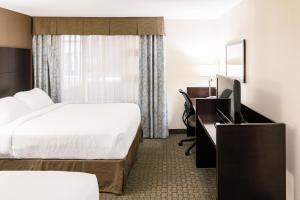 a hotel room with two beds and a television at Rodd Royalty in Charlottetown
