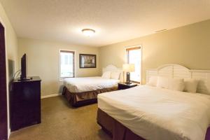 a bedroom with two beds and a television in it at Bay Colony- Unit 764 - Lower in Nisswa