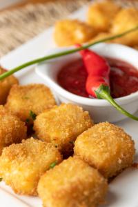 a plate of food with a bowl of dipping sauce at Pousada Algodão da Praia in Araruama