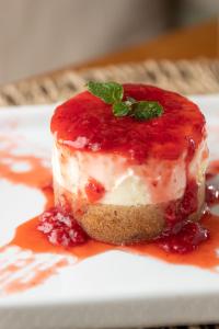 a piece of cake on a white plate at Pousada Algodão da Praia in Araruama