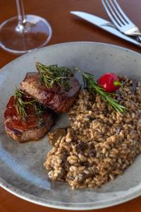 a plate of food with meat and beans on a table at Pousada Algodão da Praia in Araruama