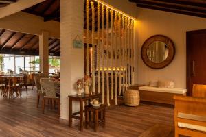 a dining room with a table and a mirror at Pousada Algodão da Praia in Araruama