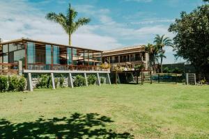 a house with a large yard in front of it at Pousada Algodão da Praia in Araruama