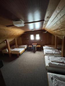 a room with several bunk beds in a cabin at Chata Matičiar in Martin