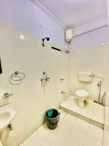 a bathroom with a toilet and a sink at Blue King in Jaipur