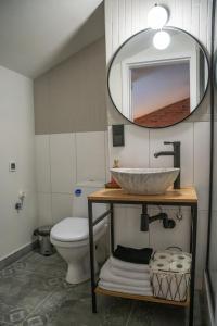 a bathroom with a sink and a toilet and a mirror at Moon Hostel Warszawa in Warsaw