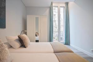 Ένα ή περισσότερα κρεβάτια σε δωμάτιο στο Barcelona Eixample