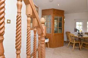 a spiral staircase leading to a kitchen and dining room at Briar Cottage in Kirk Ireton