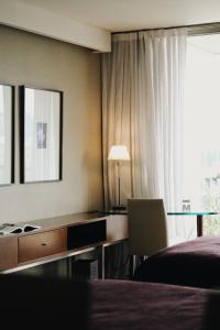 
a hotel room with two beds and a television at Hotel Madero Buenos Aires in Buenos Aires
