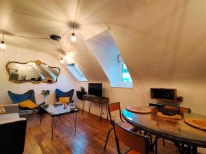 a living room with a couch and a table at ConcarnOLoc in Concarneau
