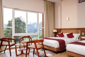 Postel nebo postele na pokoji v ubytování THRILL HOLIDAYS MUNNAR
