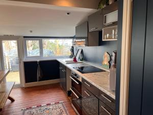 a kitchen with a sink and a stove top oven at The Boho - 4 min walk to beach & town in Bournemouth