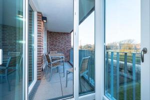 a patio with a table and chairs on a balcony at Apartmentvilla Anna See Apartmentvilla Anna See 2-12 in Langeoog
