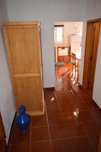 a room with a door and a tiled floor at Casa da Avó Vitória in São Pedro do Corval