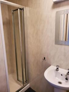 a bathroom with a shower and a sink at the cumbrian hotel in Blackpool