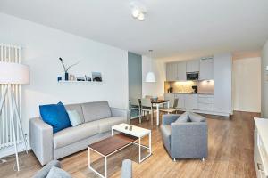 ein Wohnzimmer mit Sofa und Tisch in der Unterkunft Deichhäuser Anna Küste Deichhäuser Anna Küste 4-20 in Bensersiel