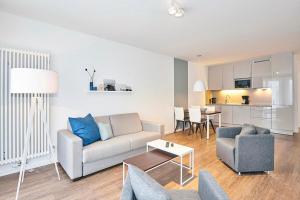 ein Wohnzimmer mit Sofa und Tisch in der Unterkunft Deichhäuser Anna Küste Deichhäuser Anna Küste 4-10 in Bensersiel