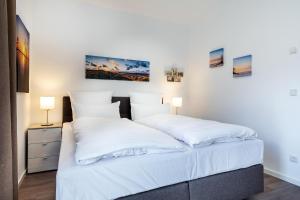 Postel nebo postele na pokoji v ubytování Aparthotel Ostseeallee Aparthotel Ostseeallee 4-33
