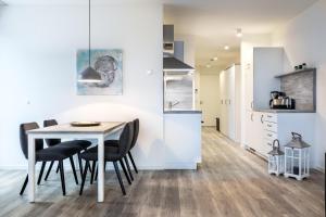eine Küche und ein Esszimmer mit Tisch und Stühlen in der Unterkunft Apartmentanlage Meerblickvilla Apartmentanlage Meerblickvilla 2-18 in Großenbrode