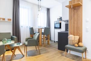 a living room with a table and chairs and a kitchen at Ferienapartments am Krusespeicher Ferienapartments am Krusespeicher 2-19 in Wismar